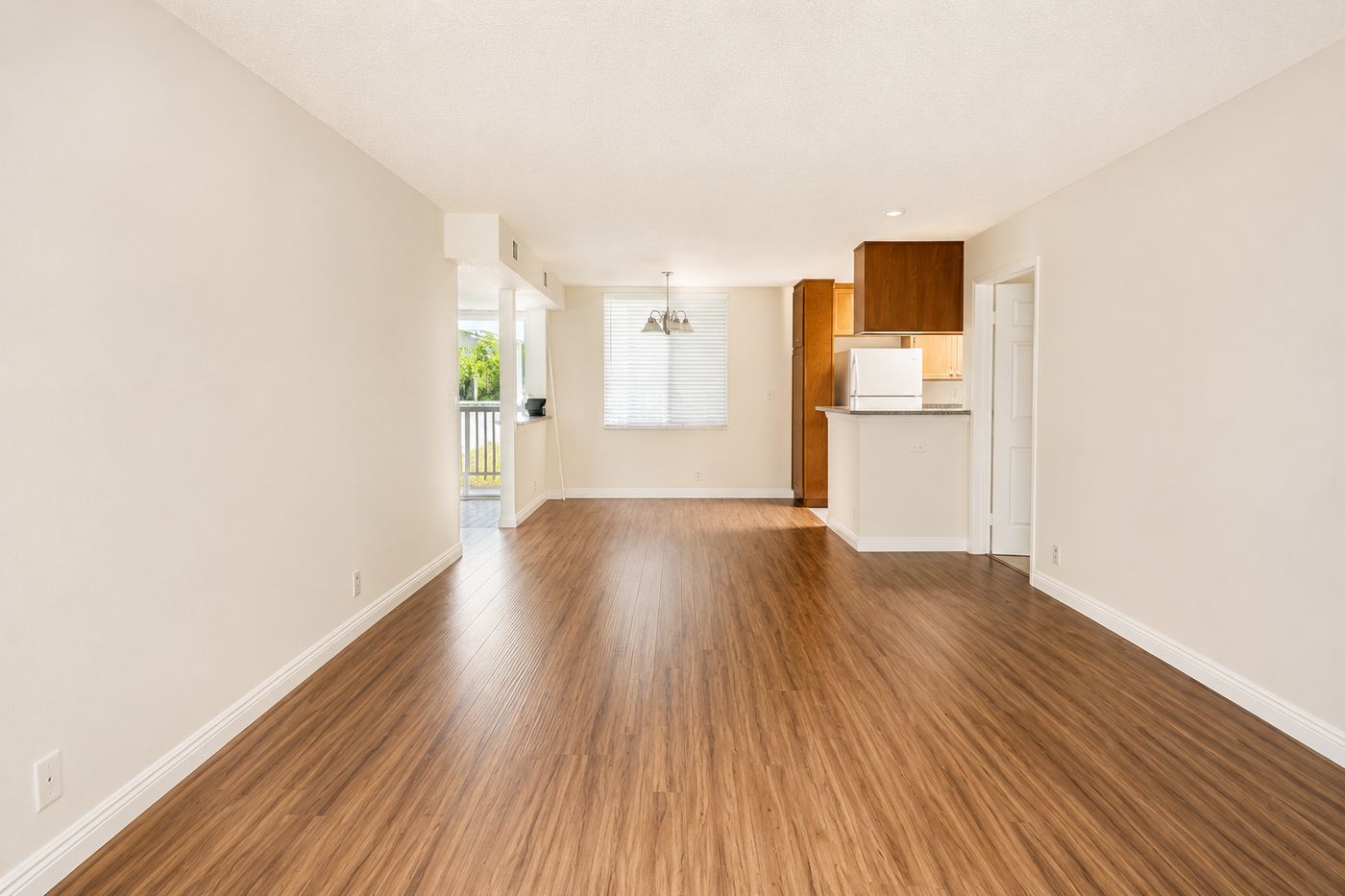 Bright open living and dining room with wood floors