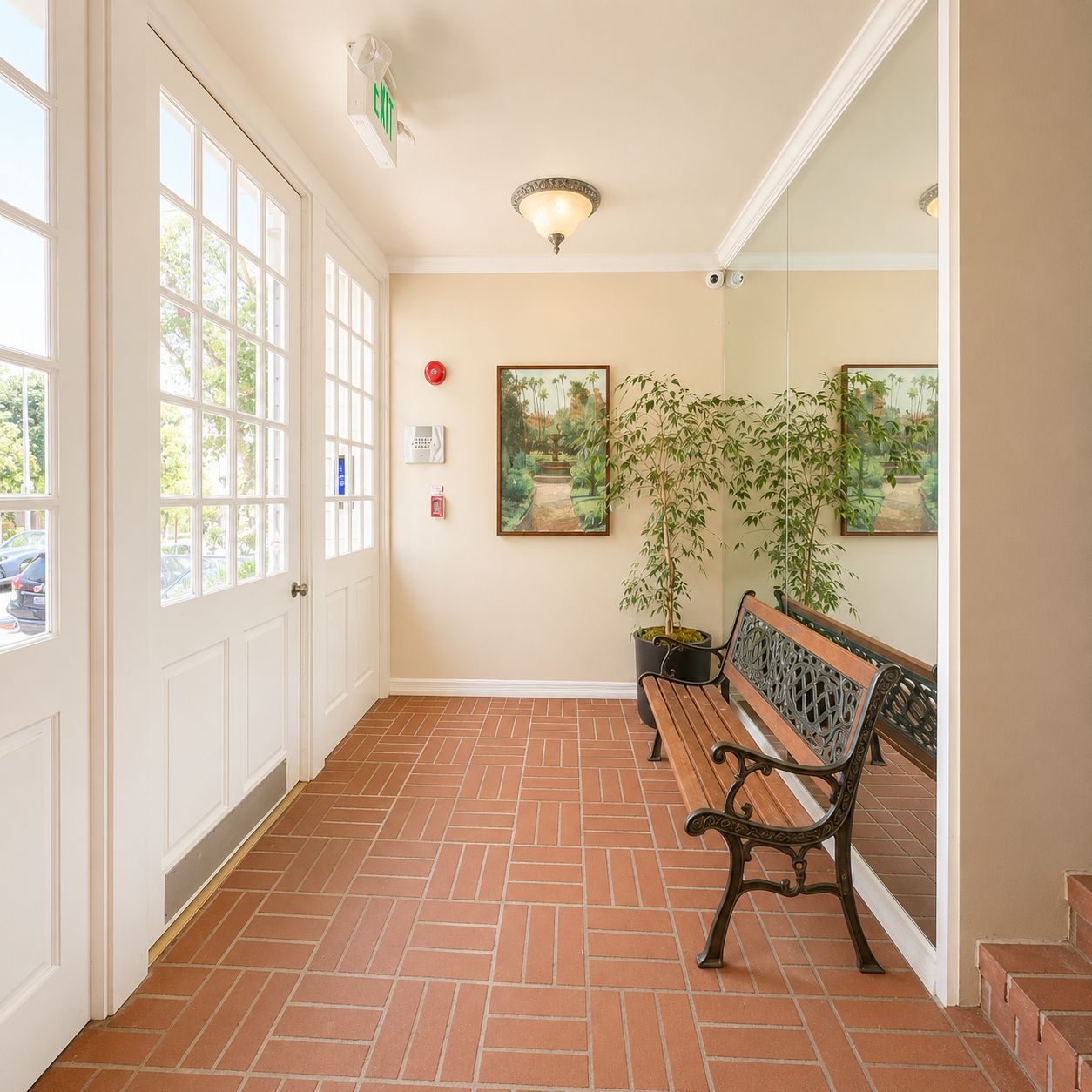 Entry lobby with brick floor and garden bench